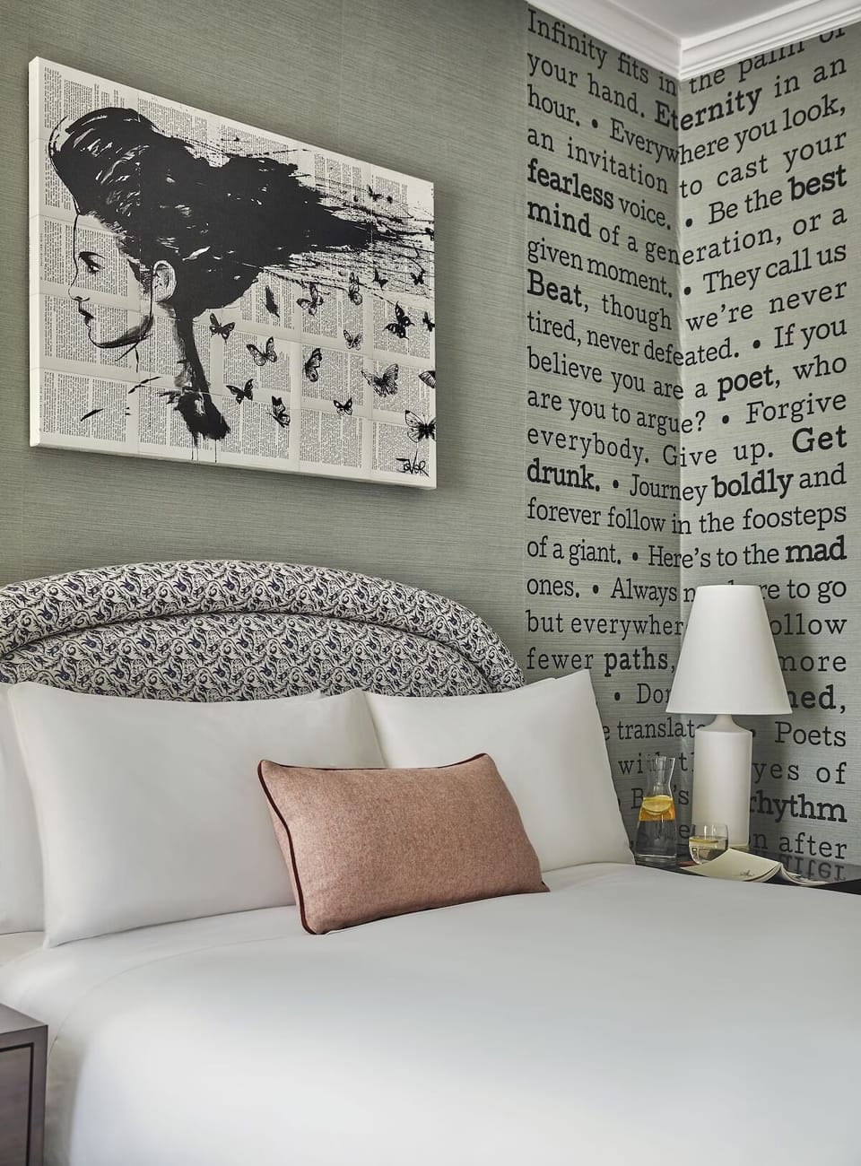 Drift off beneath bold art and plush, perfectly stacked pillows.