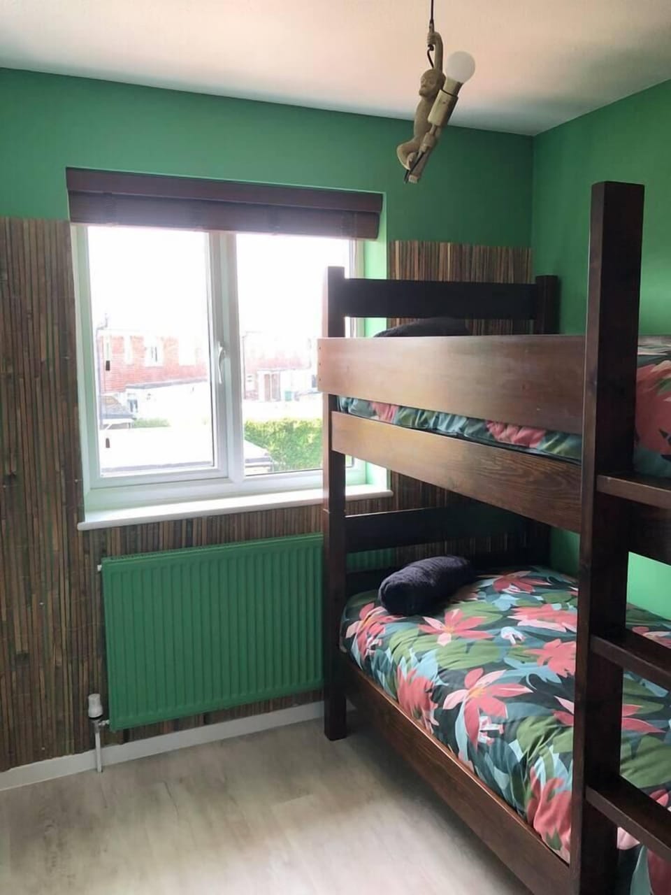 Forest themed room for kids with single bunk beds.