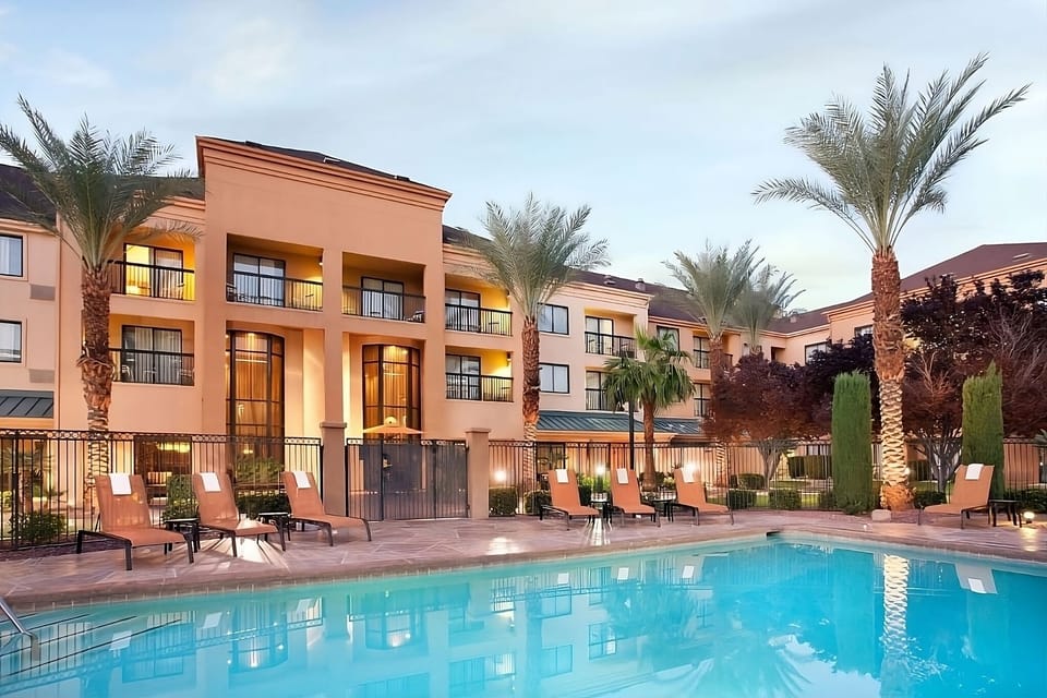 Dive into a serene poolside escape with sunset reflections.