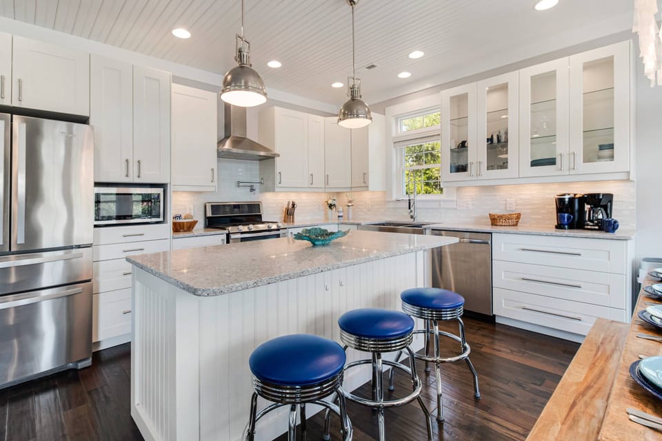 In this Chef's Kitchen is a Large Kitchen Island with a Breakfast Bar. The Island is More Prep Space & to Serve Buffet Style Meals.