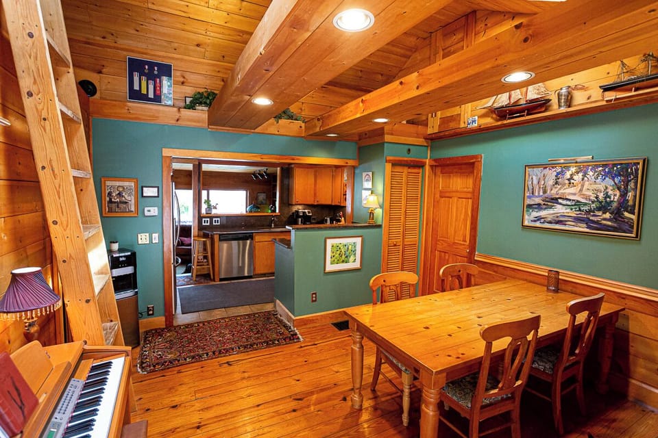 Dining room in main house.  High ceilings, electric piano & loft bedroom
