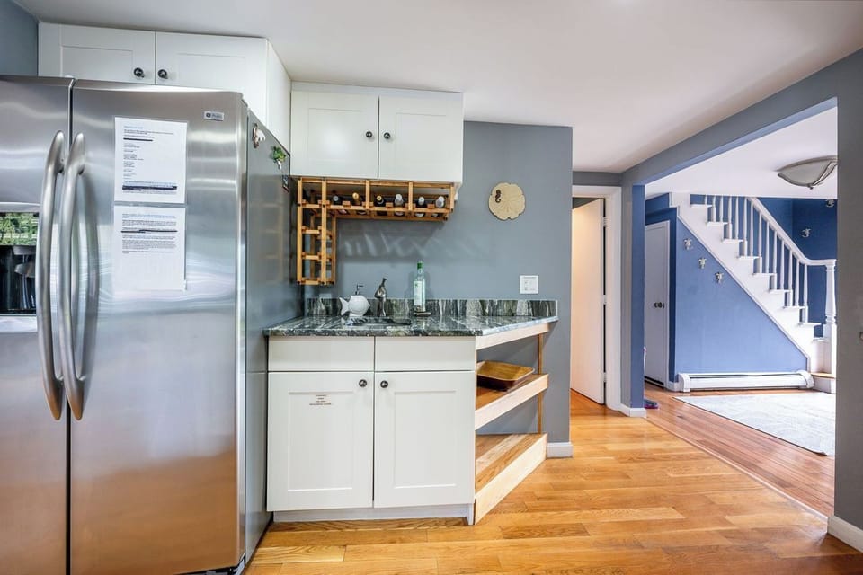 Large fridge with wine racks and additional sink.