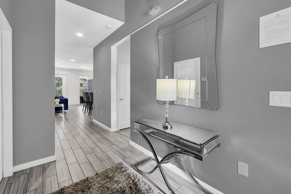 Modern entryway with decorative wall mirror, console table, and stylish lighting.