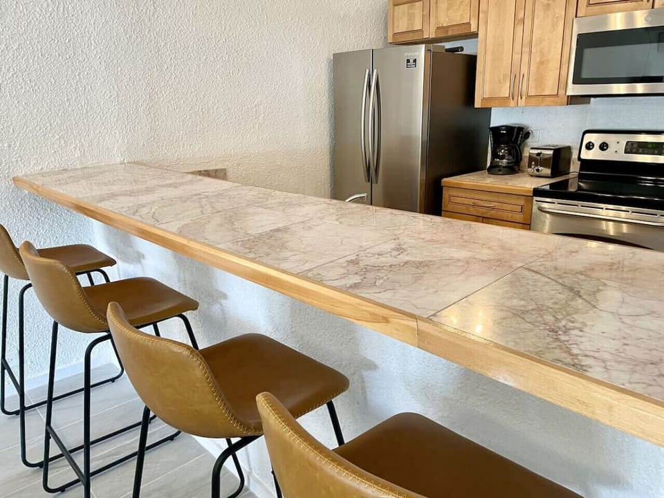 A well equipped kitchen with generous counter space, bar seating, and everything your family needs to cook meals