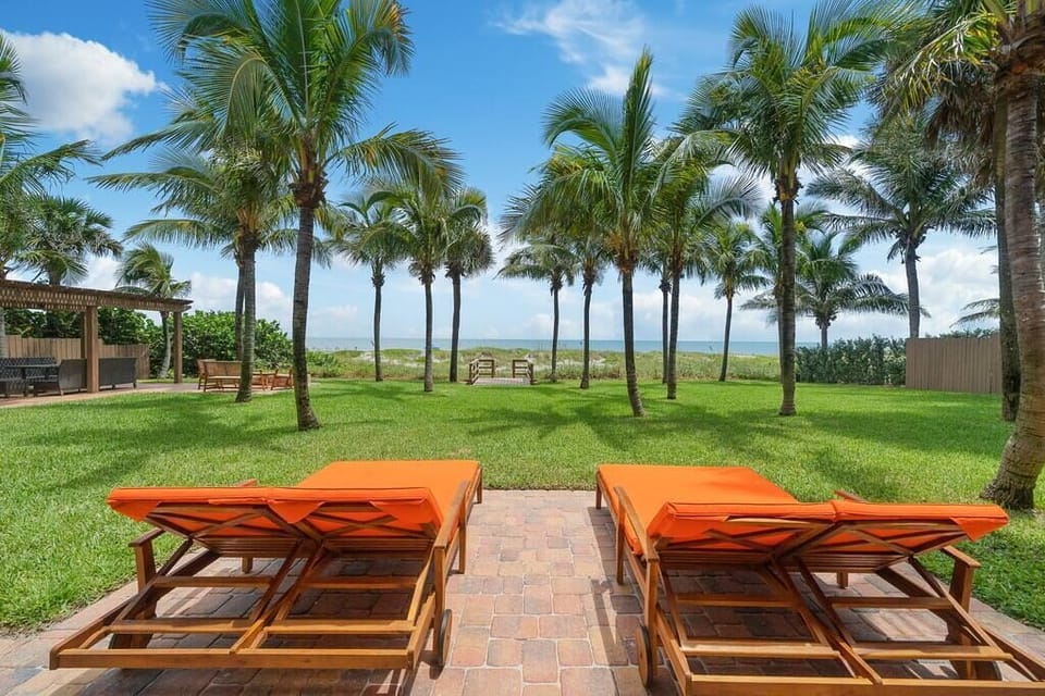 Take in the sun, beach and ocean on double chaise lounge chairs.