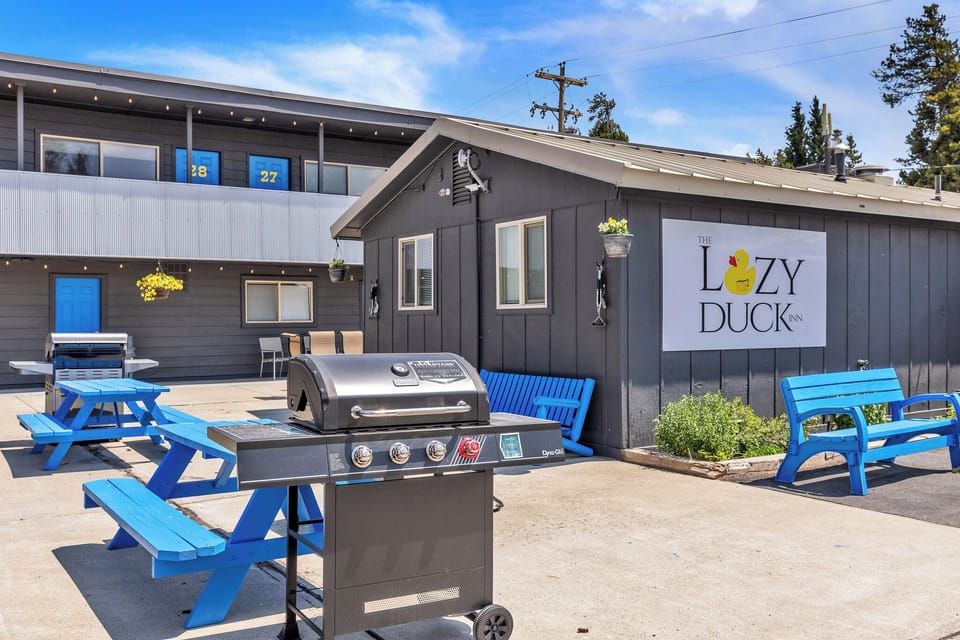 Outside patio with benches, picnic tables and grills for communal use