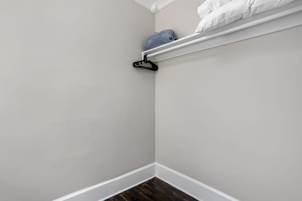 Blue Room Storage Space: Ample shelving and hangers for your belongings, keeping your stay organized!