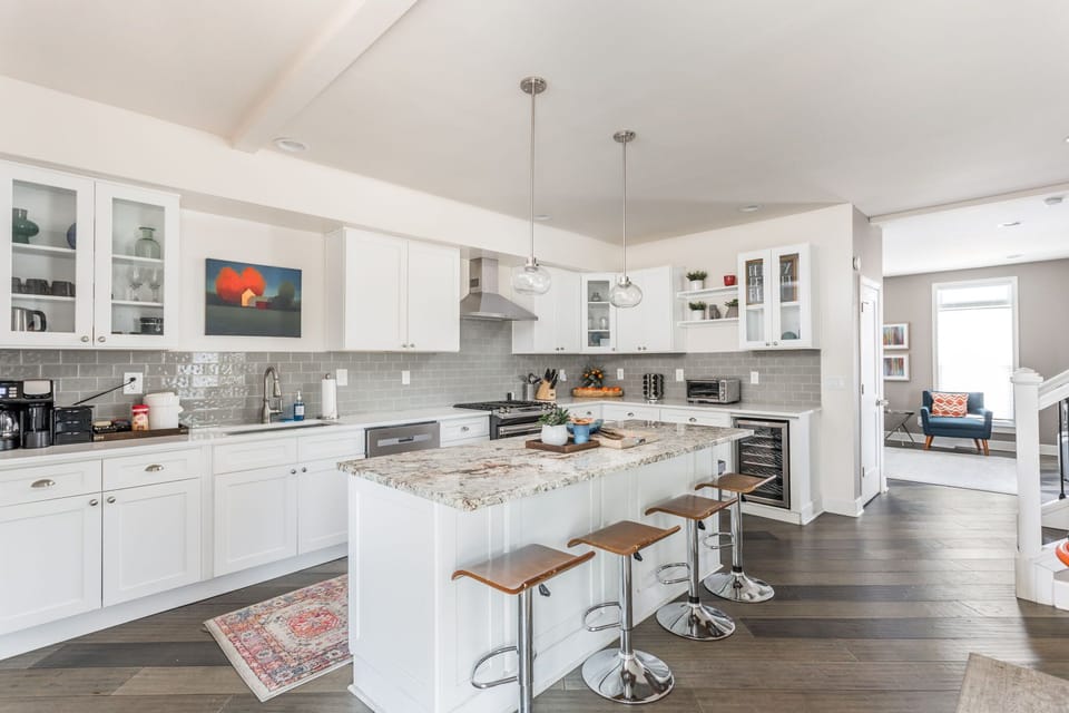 Our kitchen features bar seating, modern appliances, a coffee station, and all the basic essentials needed for your stay!