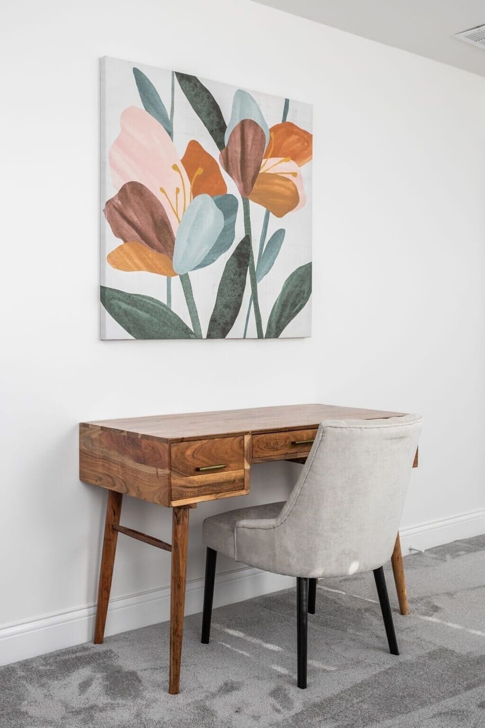 Workspace: Enjoy a stylish desk and chic chair with vibrant floral art for inspiration!