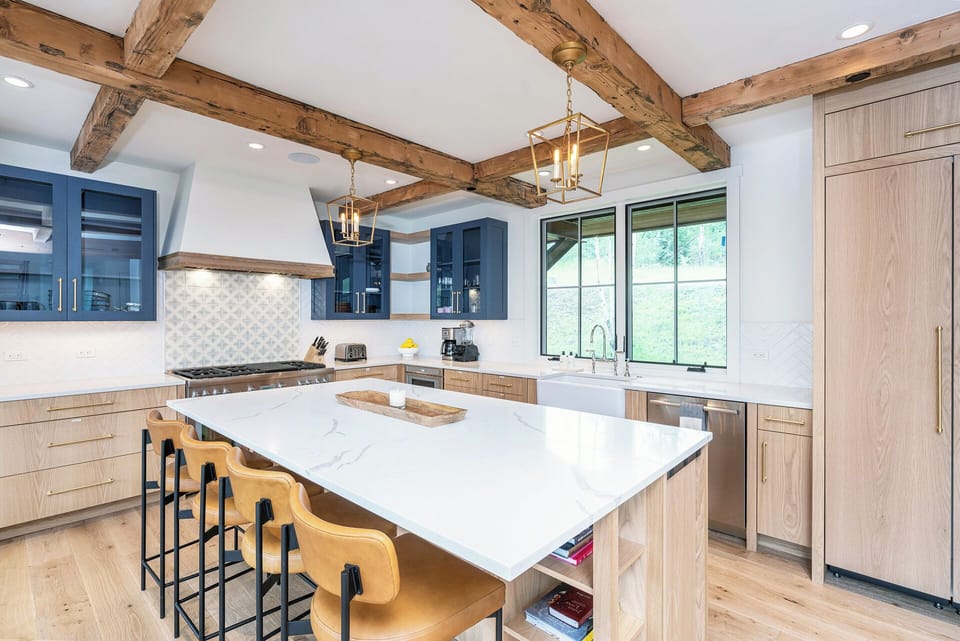 A modern chef's kitchen equipped with stainless steel appliances, a 6-burner gas stove with a griddle, and all the amenities needed to host you and your family in style.