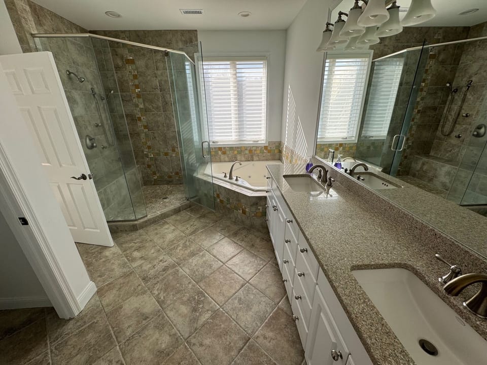 Primary bathroom with steam shower and jacuzzi tub