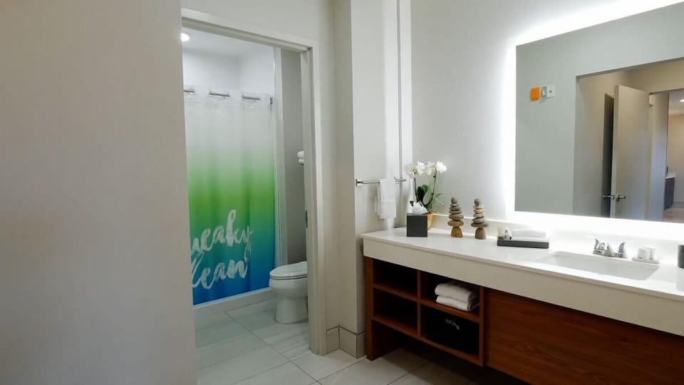 Freshen up with a sleek vanity and bright, clean bath.
