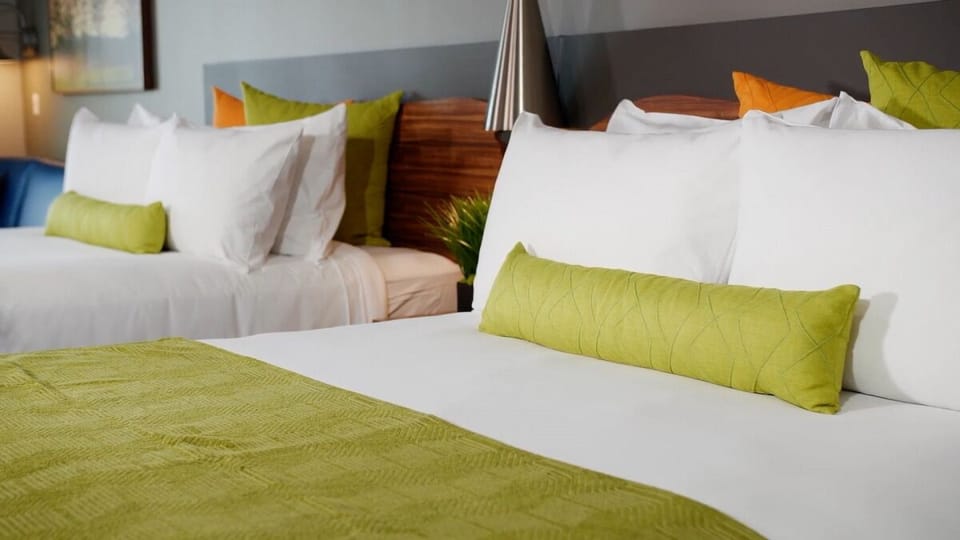 Unwind in crisp bedding with cozy, colorful pillows.