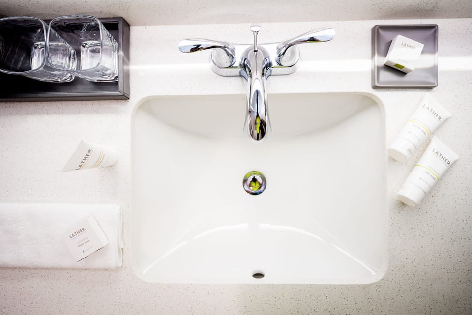 Refresh with neatly stocked essentials on a sparkling modern sink.