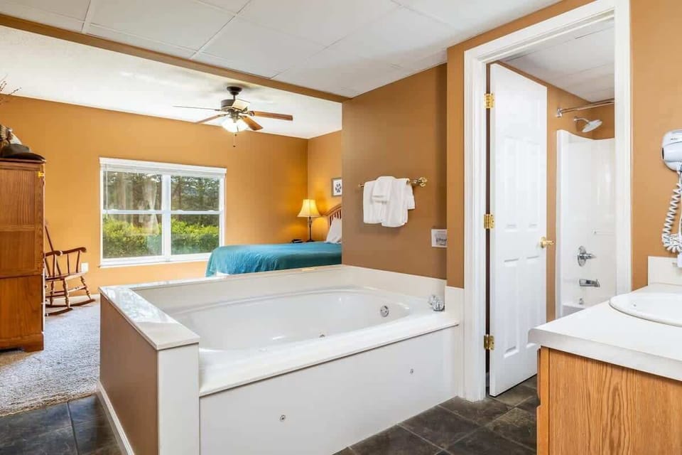 Indulge in relaxation in our stylish soaker tub—share the luxury or enjoy it solo!