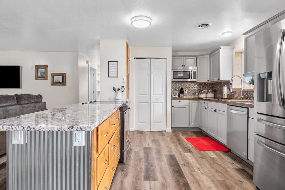 Prepare delicious meals in our fully equipped kitchen, featuring stainless steel appliances and ample counter space.