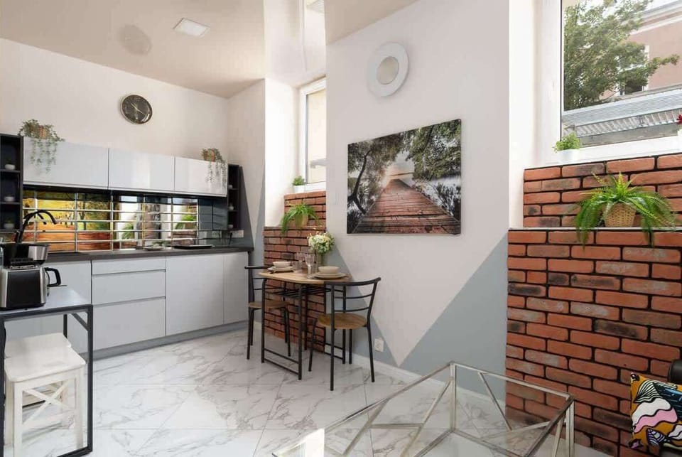 Well-equipped kitchenette featuring a small dining space, blending practicality and style.


