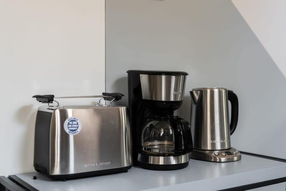 Bright kitchenette with a view of the coffee and tea station, featuring a kettle and coffee maker for convenience.

