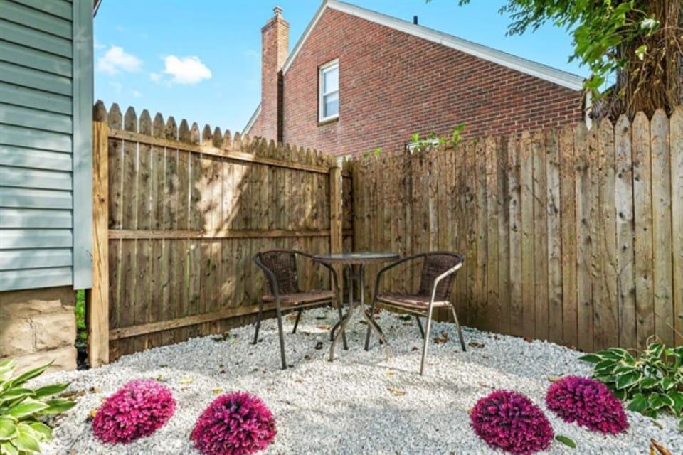 Generously sized yard featuring a fire pit and seating chairs.