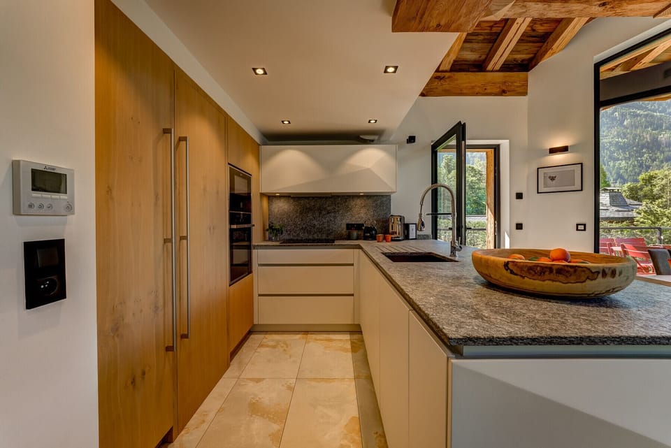 Kitchen with stone worktops and walk-in pantry