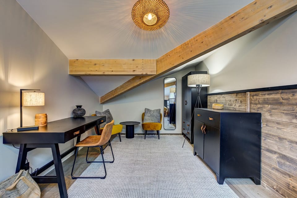 Bedroom 3, spacious with a desk and cosy seating area