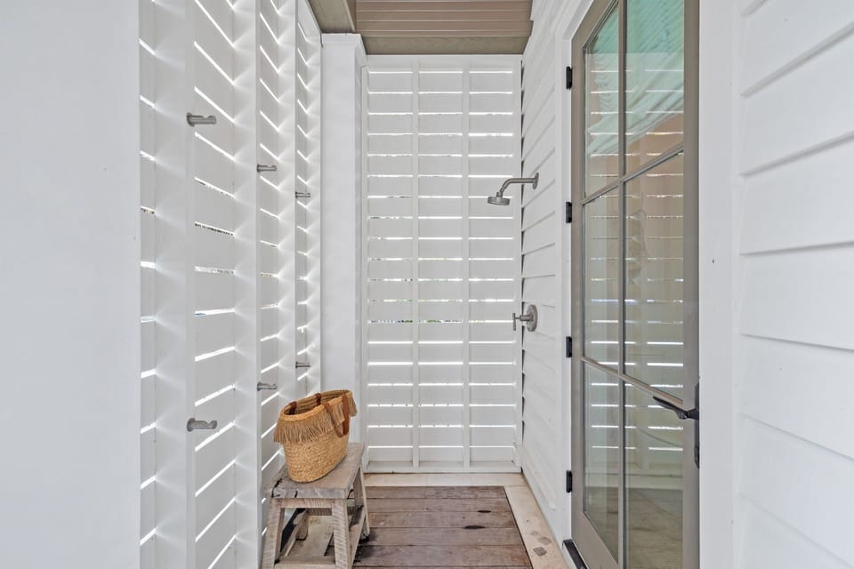 Outdoor shower. Door leads to powder room