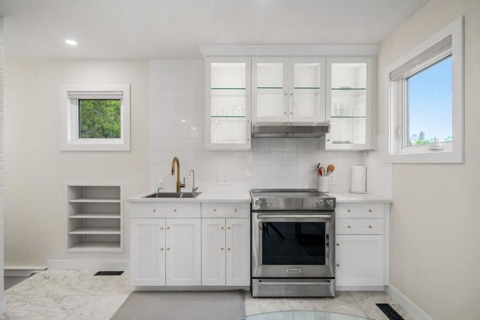 Kitchen area on the main floor with a mini fridge, smart TV, dining area, stove/oven, drip coffee maker, ground coffee, tea, sugar and basic condiments (ketchup, mustard and relish.)