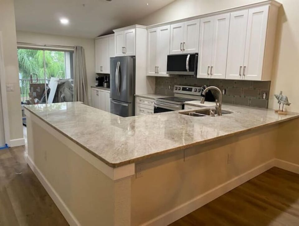 Completely remodeled kitchen with stainless steel appliances and Quartzite