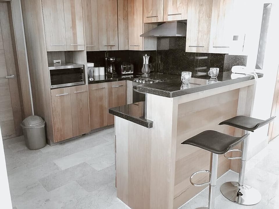 Unleash your culinary creativity in our full-size kitchen.  Equipped with top-of-the-line modern appliances, this culinary haven provides everything you need to cook up a storm.  Prepare delicious meals with ease and style in this well-appointed kitchen.  
