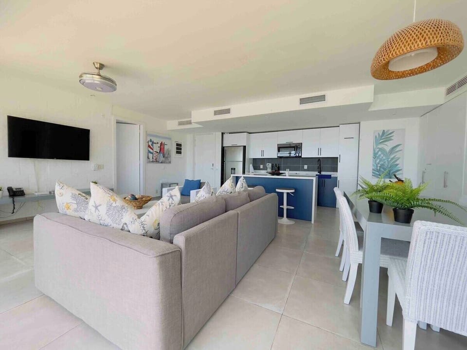 Welcome to our open and spacious living area, where the kitchen, dining room and living room seamlessly blend together, all while offering breathtaking sea views.