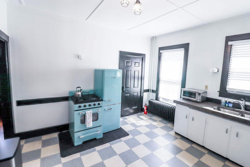 Kitchen with gas range, toaster oven, & coffee machine.  We provide ground coffee, sweetener, and creamers