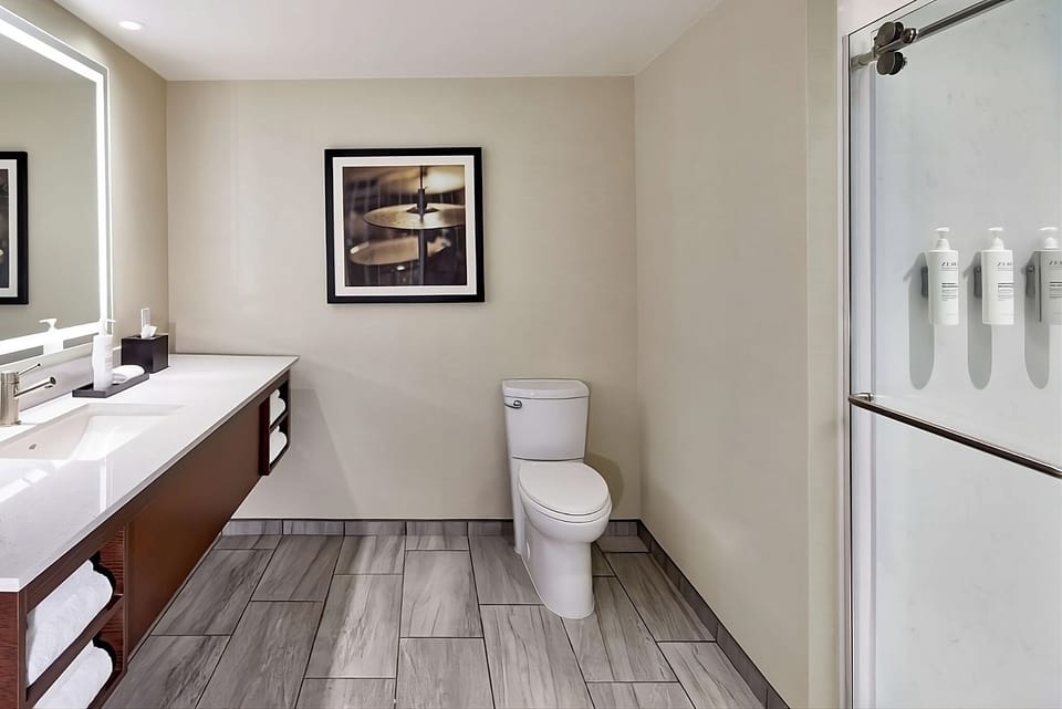 Enjoy a spotless bathroom layout with shower and fresh towels.