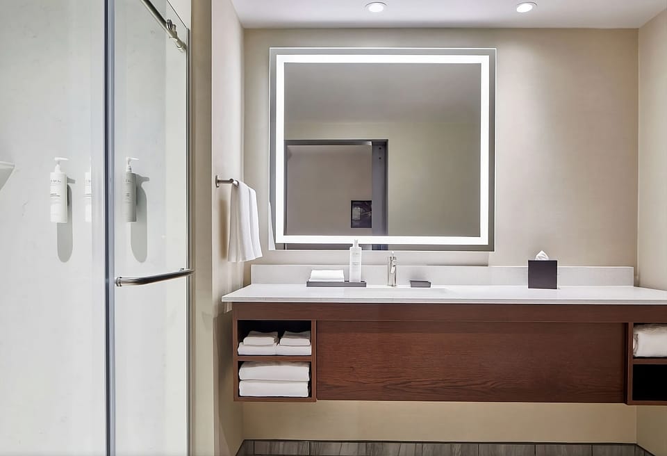 Get ready with flattering backlit mirror and ample counter space.
