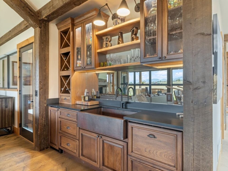 Bar outfitted with glassware, large capacity ice maker and two fridge drawers
