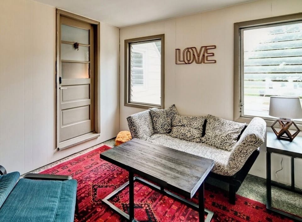 Cozy living room with television and open concept to kitchen.