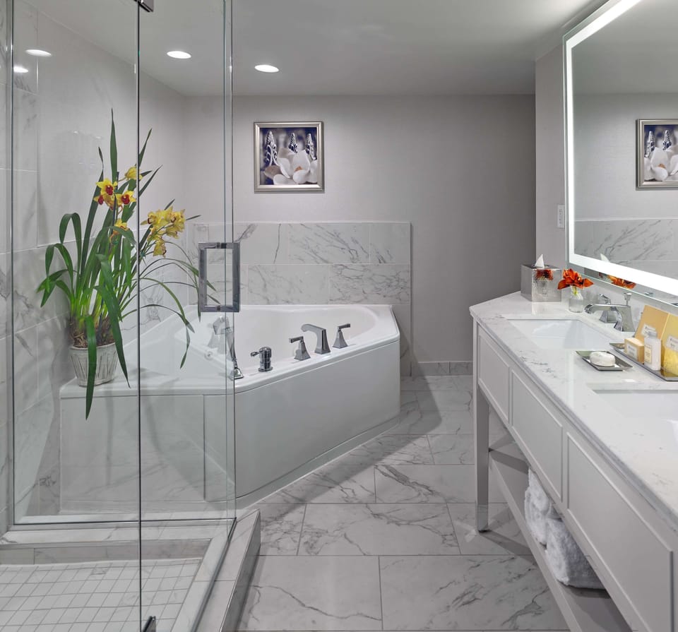 Refresh in a spa-like marble bath with glass shower.