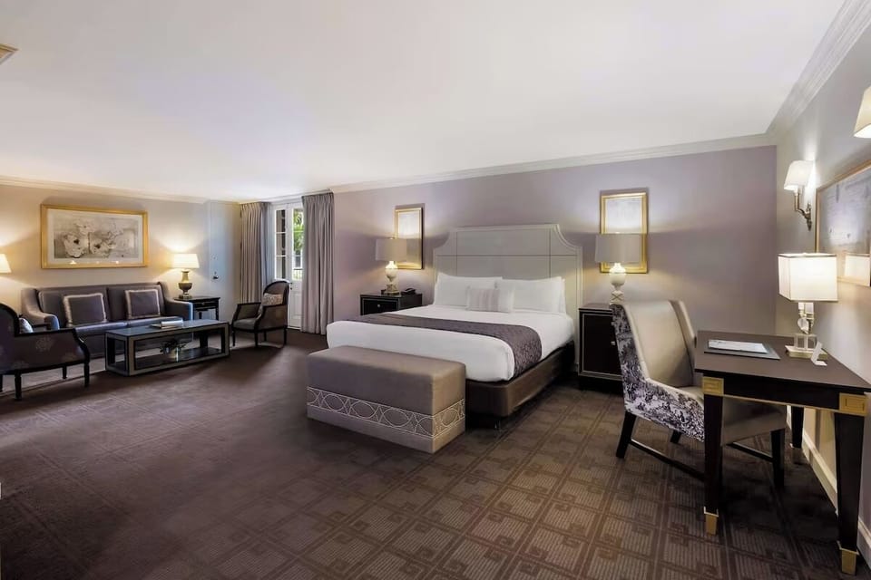 Unwind in a spacious bedroom with plush bedding and warm lighting.