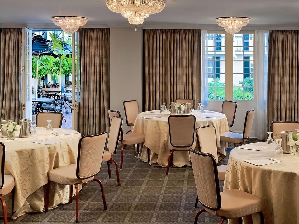 Gather for leisurely meals under sparkling chandeliers and soft daylight.