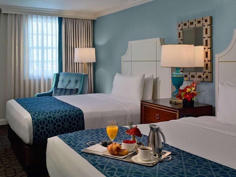 Wake up to breakfast in bed beside soothing blue tones.