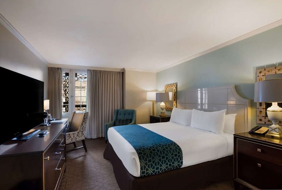 Relax in the comfortable king bedroom with desk and TV.
