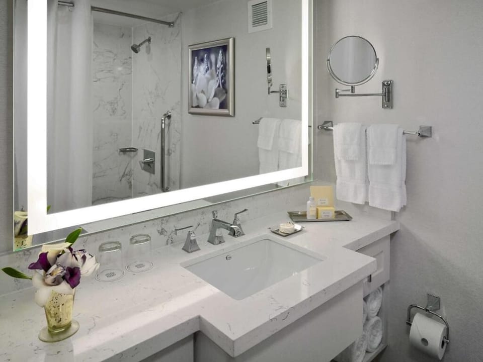 Refresh in a bright, spa-like bath with glowing vanity mirror.