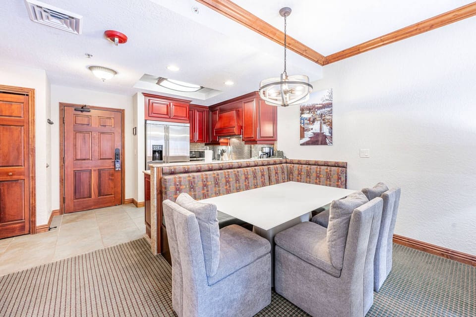 The spacious dining area provides ample seating with a stylish dining bench and two comfortable dining chairs.
