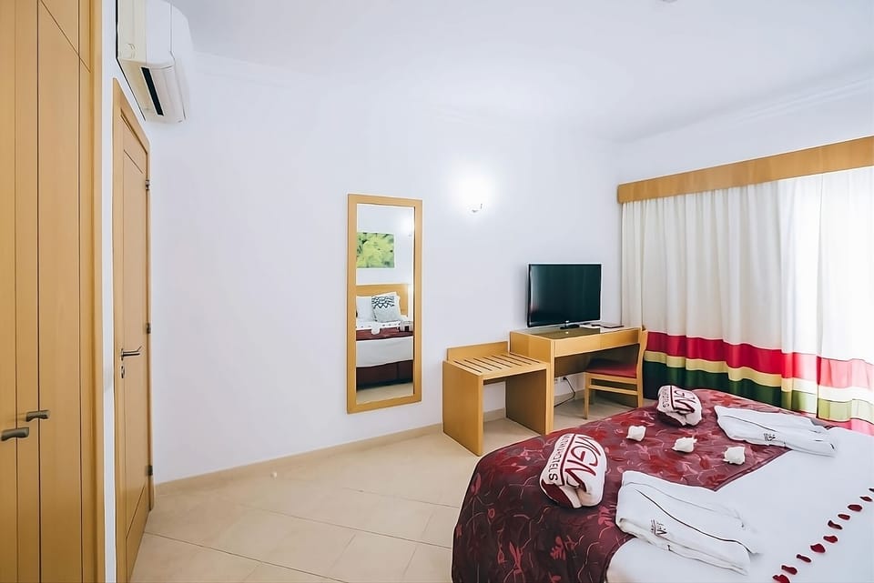 Settle in with in-room TV and a practical workspace.