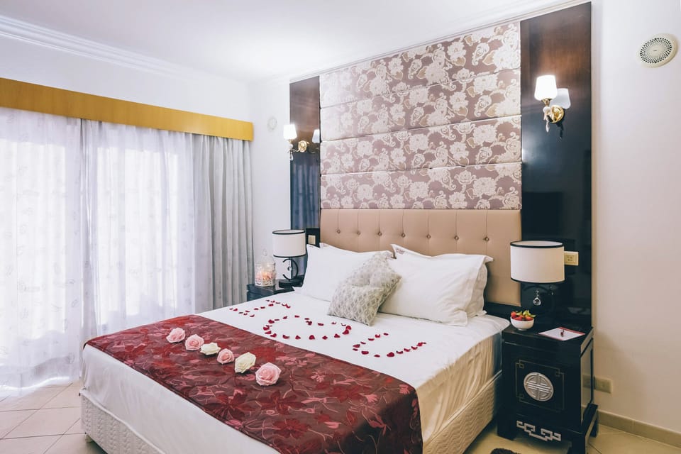 Drift off in a romantic setting with cozy bedside lighting.