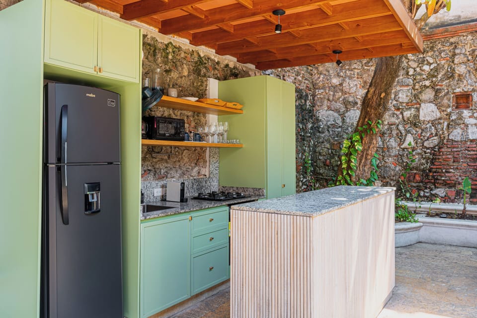 Outdoor kitchen · Open-air cooking · Colonial stone wall