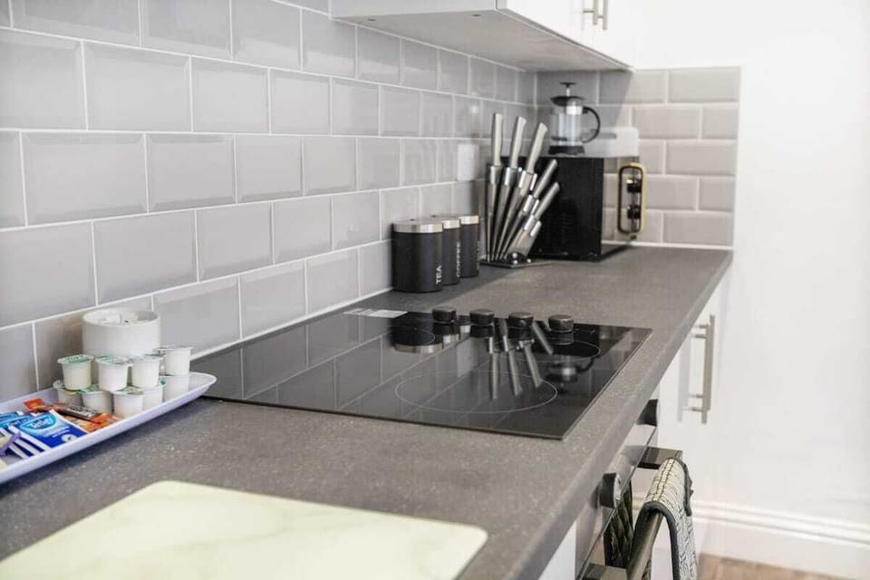 Kitchen equipped with all essentials, including a washer & dryer, oven, fridge and full cookware set.