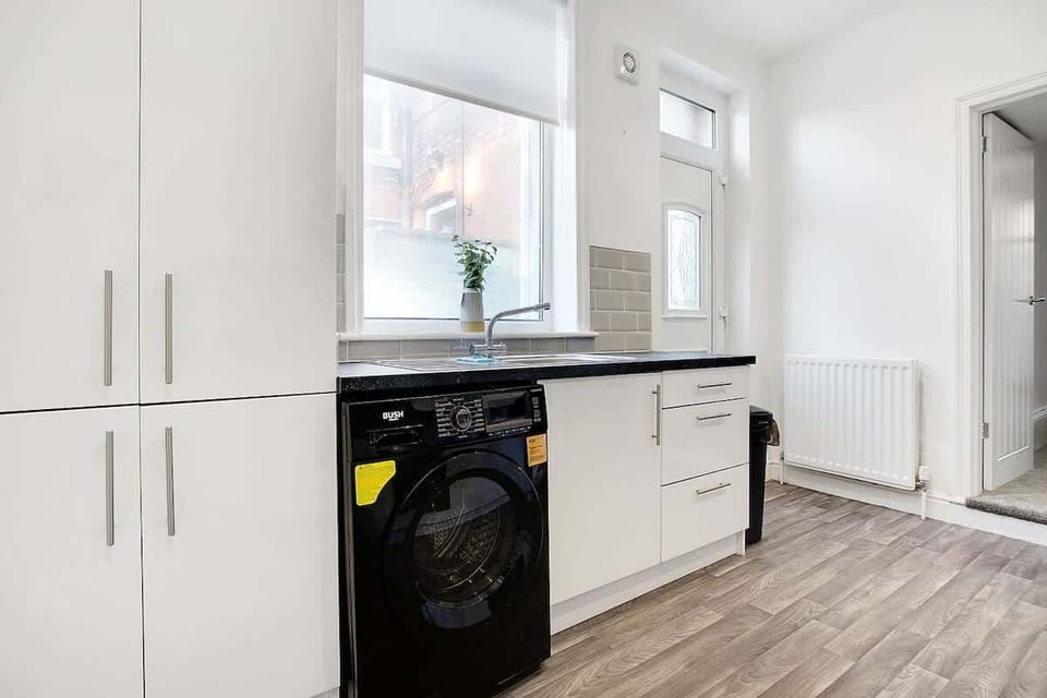 Kitchen equipped with all essentials, including a washer & dryer, oven, fridge and full cookware set.
