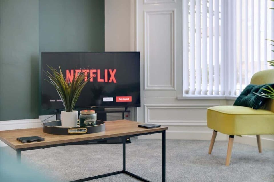 Enjoy the inviting living area with a Smart TV, generous seating, and a beautifully designed accent chair. Ideal for relaxing, socialising, or enjoying a quiet evening indoors.