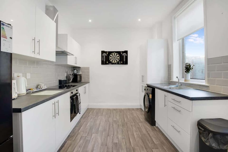Kitchen equipped with all essentials, including a washer & dryer, oven, fridge and full cookware set.