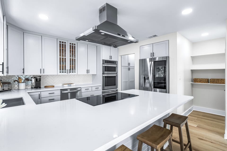 Fully Stocked Kitchen with New Quartz Counters and Bar Seating for 4